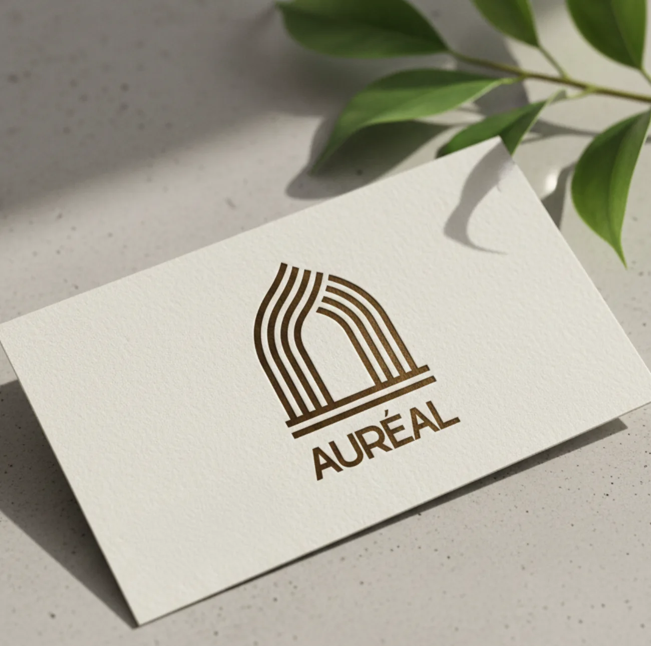 Auréal : la carte de visite, le signe et le nom imprimés couleur bronze sur un papier texturé