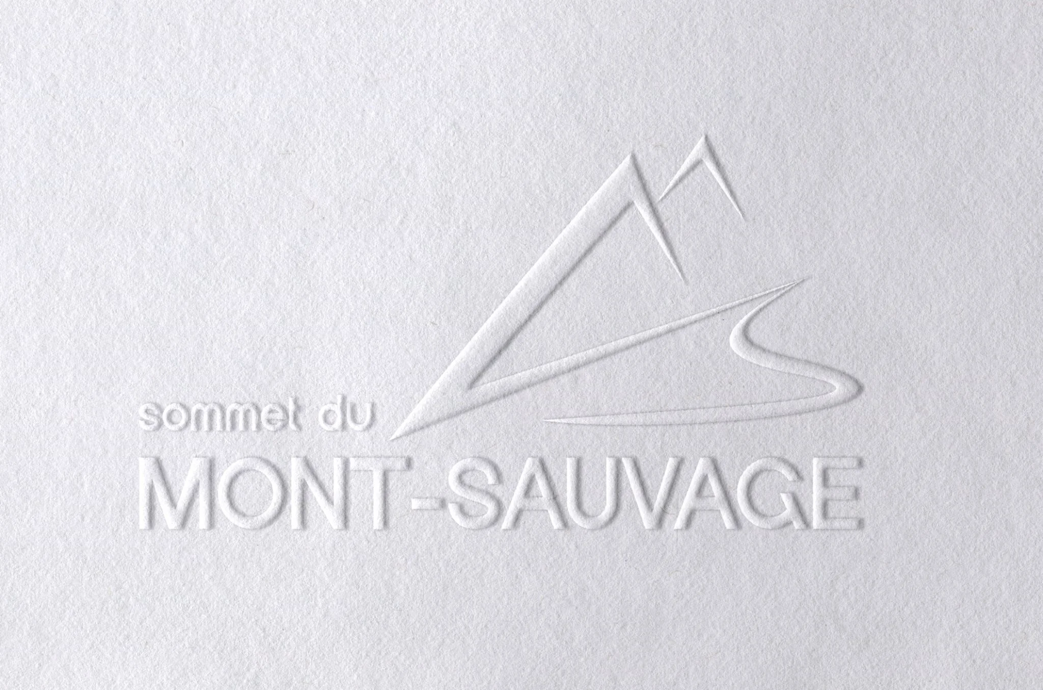 Le logo du Mont Sauvage gaufré sur un papier blanc